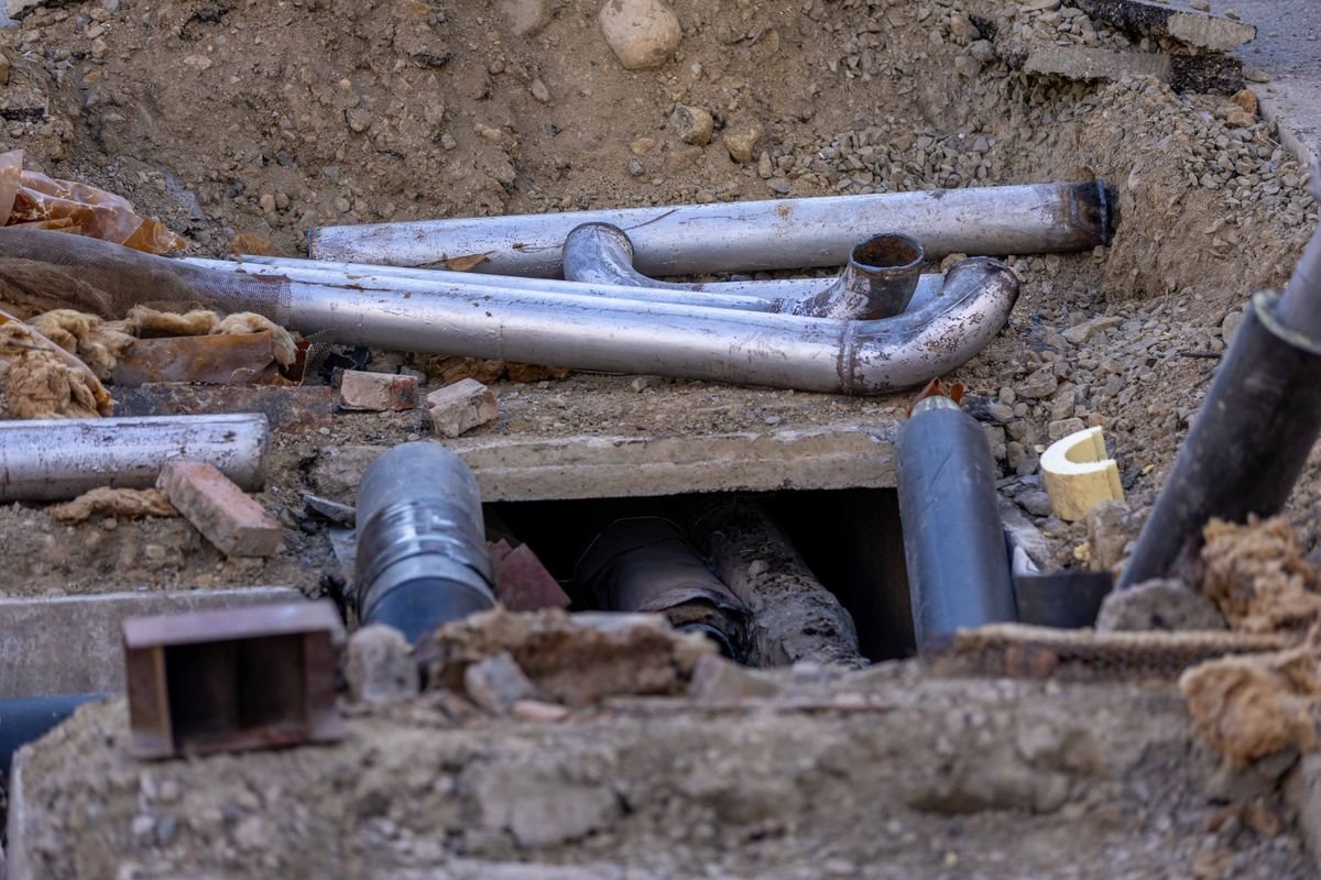 Sewer line installation work at a residential excavation site